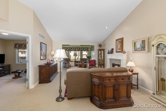 living room featuring visible vents, light colored carpet, a fireplace, and high vaulted ceiling