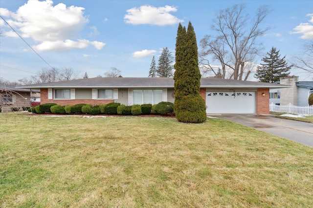 single story home with brick siding, concrete driveway, an attached garage, fence, and a front lawn