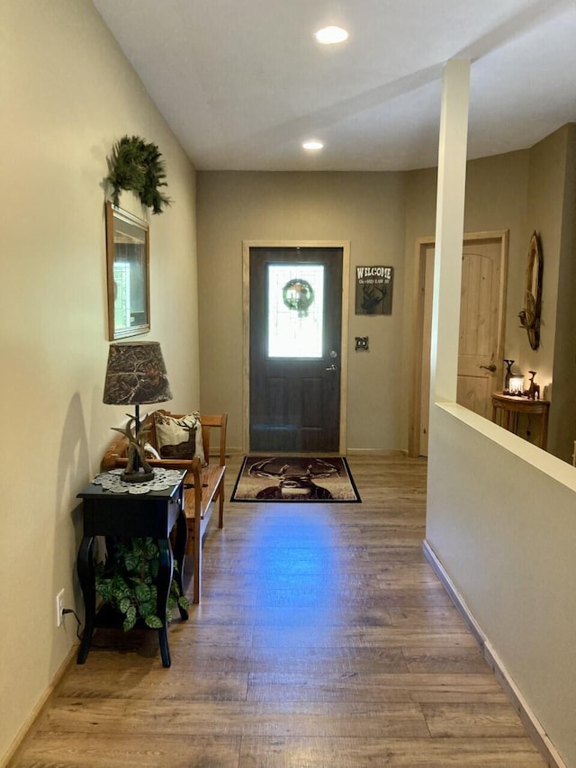 foyer with recessed lighting, baseboards, and wood finished floors