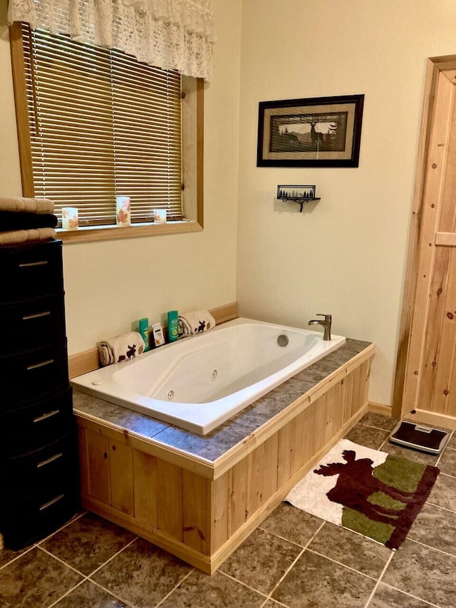 bathroom with a tub with jets