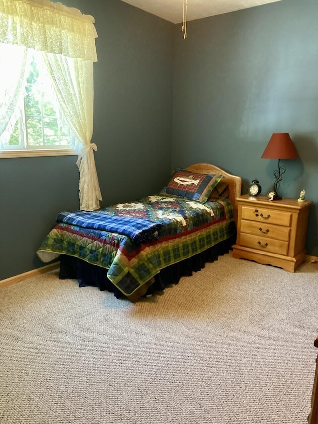 bedroom featuring carpet floors and baseboards