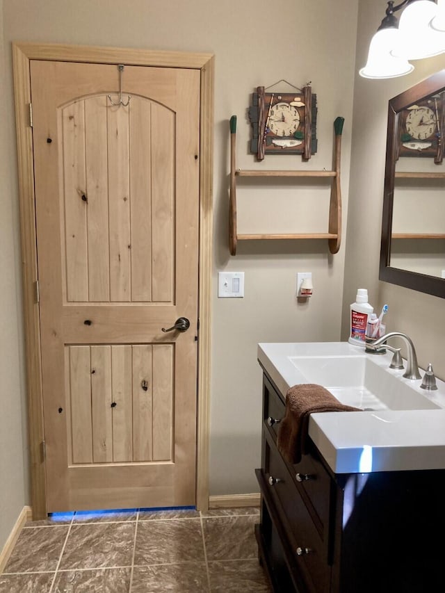 bathroom with baseboards and vanity