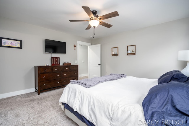 bedroom with baseboards, a ceiling fan, and light colored carpet