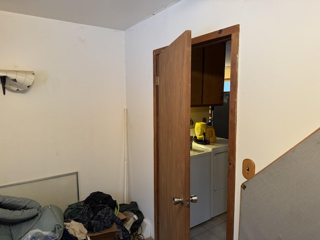 interior space featuring light tile patterned floors and washer and clothes dryer