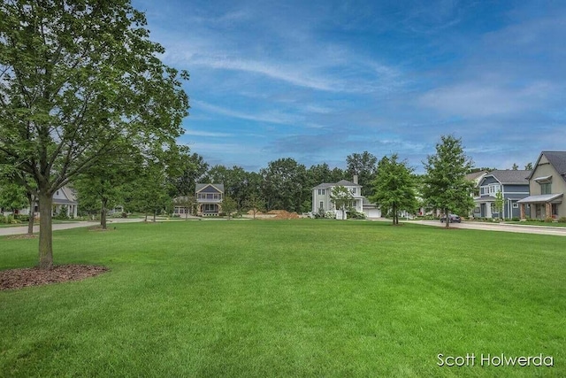 view of property's community with a residential view and a lawn