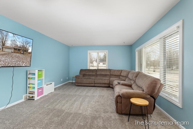 carpeted living room featuring baseboards