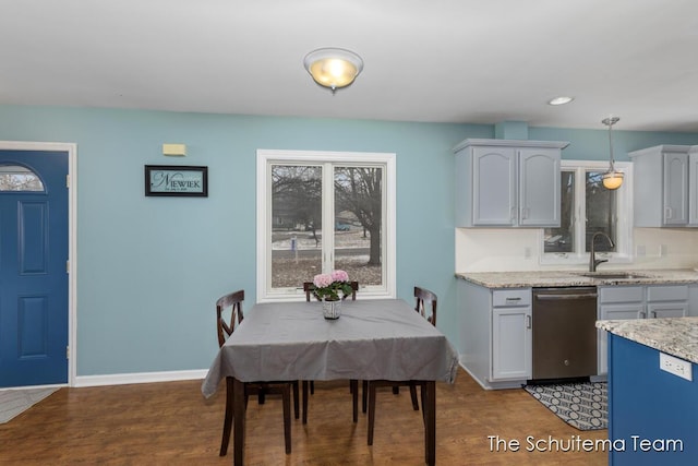 dining area featuring baseboards and wood finished floors