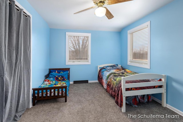 carpeted bedroom with a ceiling fan and baseboards