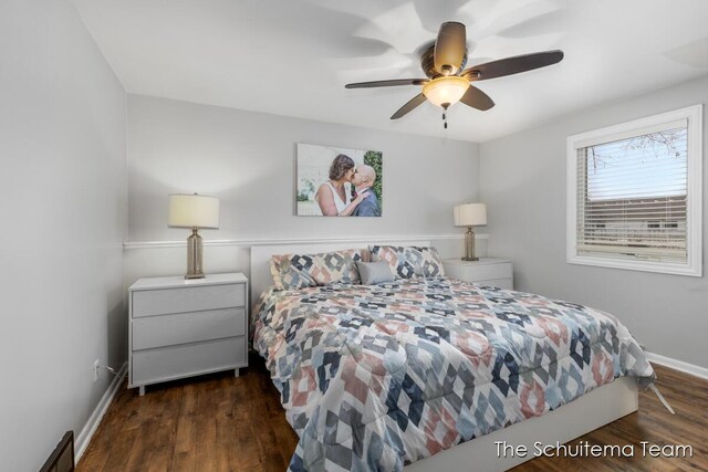 bedroom featuring ceiling fan, wood finished floors, visible vents, and baseboards