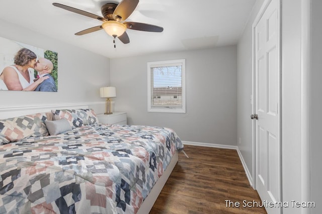 bedroom with ceiling fan, dark wood-type flooring, and baseboards