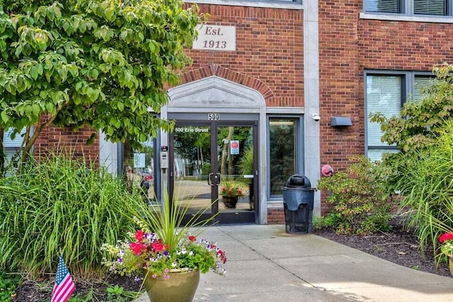 view of exterior entry with brick siding