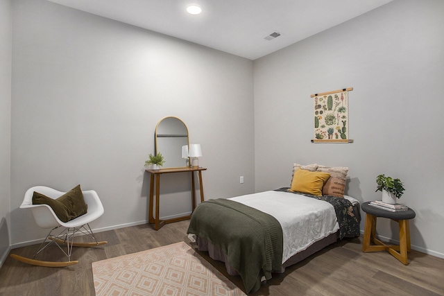 bedroom with recessed lighting, wood finished floors, visible vents, and baseboards