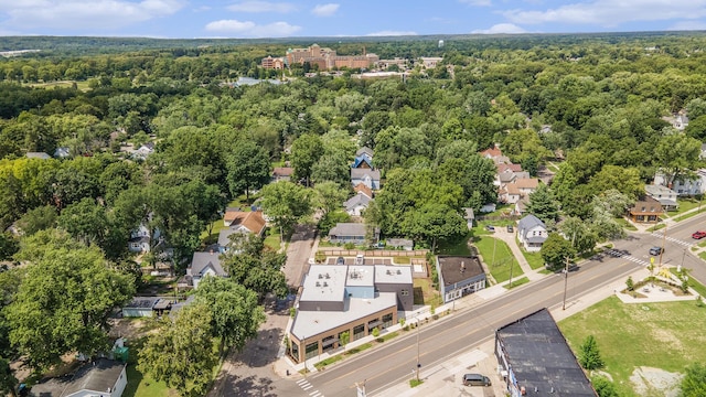 drone / aerial view featuring a residential view and a view of trees