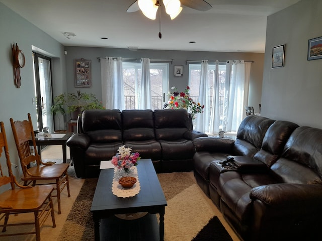 living room with a ceiling fan and visible vents