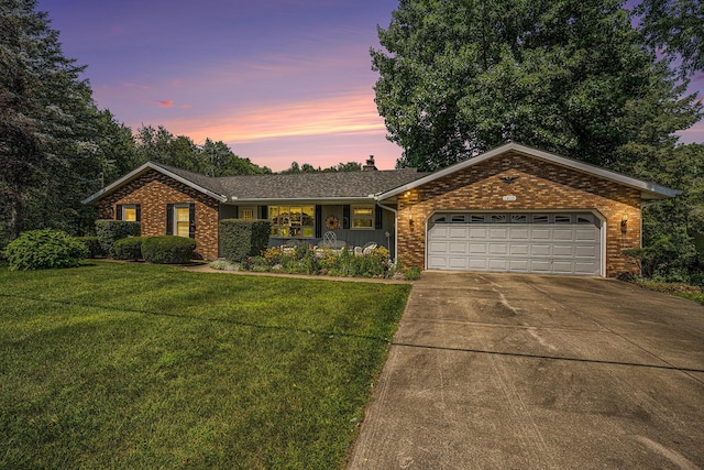 1910 W F Ave, Kalamazoo, MI 49009 - ranch-style home featuring a garage, brick siding, driveway, and a front lawn