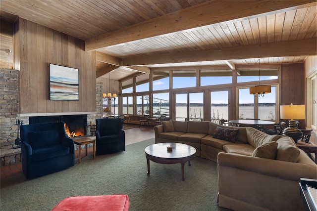 carpeted living room with a chandelier, a fireplace, wooden ceiling, and vaulted ceiling with beams