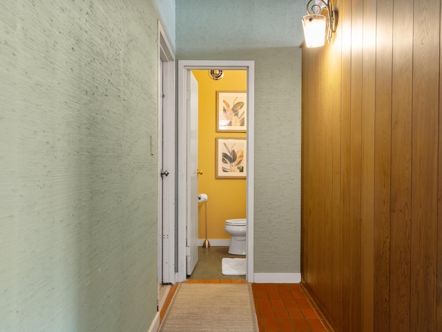 hall featuring baseboards