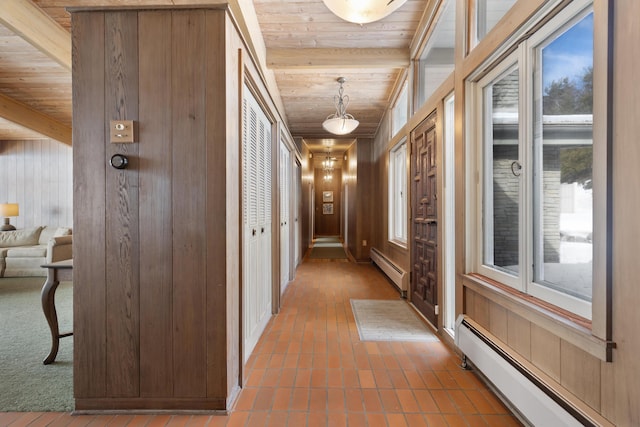 hallway featuring wood ceiling, plenty of natural light, and a baseboard radiator