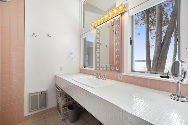 bathroom featuring tile patterned flooring, visible vents, and a sink