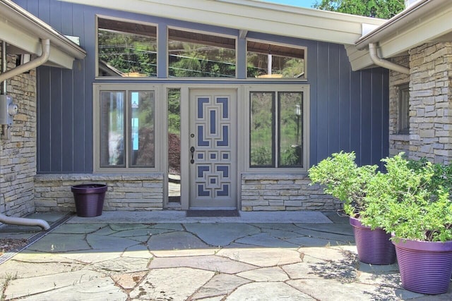 entrance to property featuring stone siding