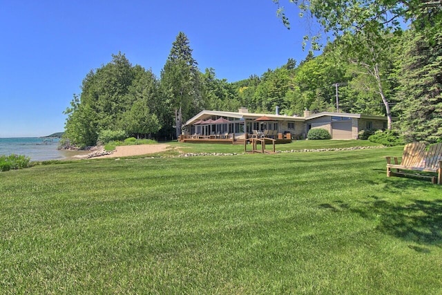 exterior space with an attached garage and a deck with water view