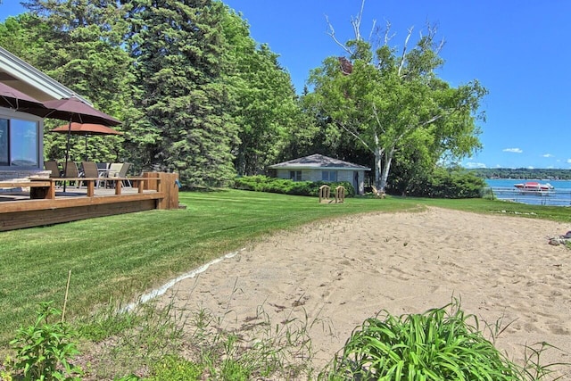 view of yard with a deck with water view