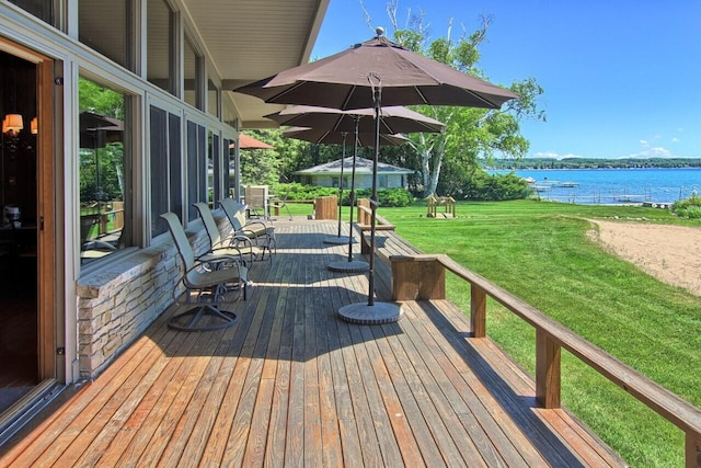 wooden terrace featuring a yard and a water view