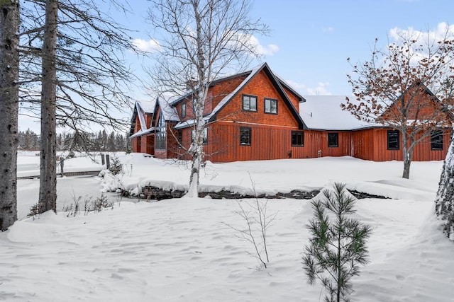 view of snow covered rear of property