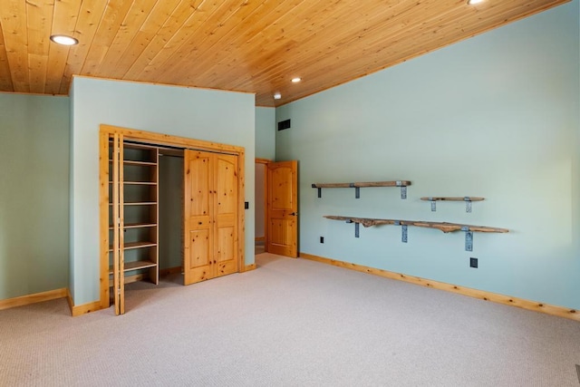 unfurnished bedroom featuring carpet floors, wood ceiling, visible vents, and baseboards