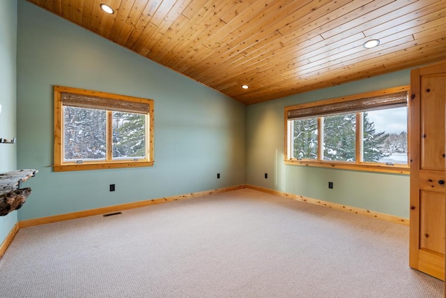 spare room with a wealth of natural light, visible vents, vaulted ceiling, and baseboards