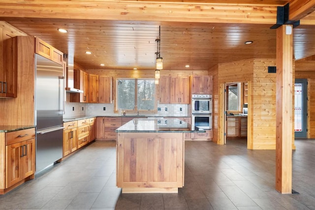 kitchen with a center island, stainless steel appliances, recessed lighting, wooden ceiling, and wall chimney exhaust hood