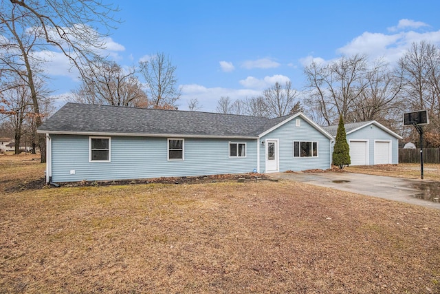 single story home with a front yard, roof with shingles, a detached garage, and an outbuilding