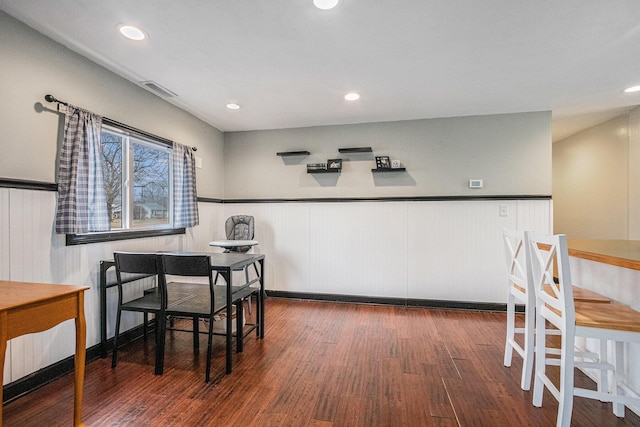 dining room with recessed lighting, visible vents, wood finished floors, and wainscoting