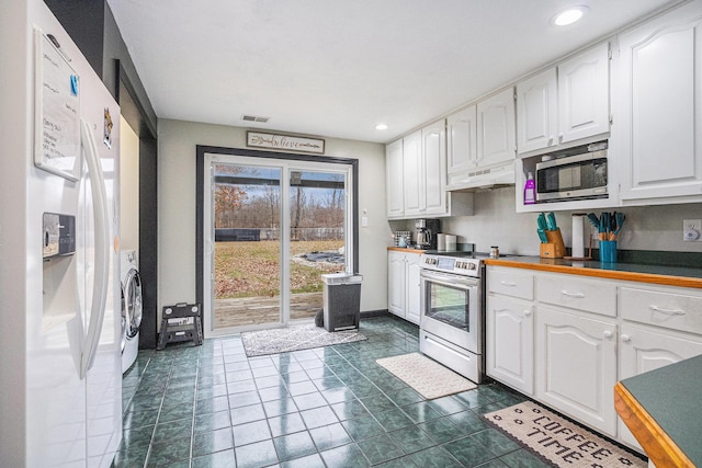 kitchen with white cabinetry, visible vents, and stainless steel appliances