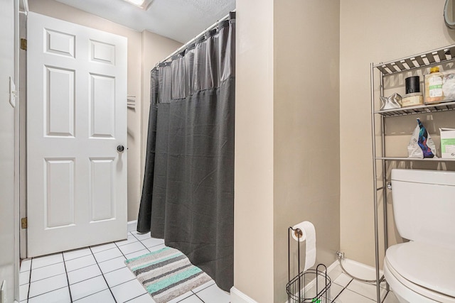 bathroom featuring baseboards, tile patterned flooring, toilet, and a shower with curtain