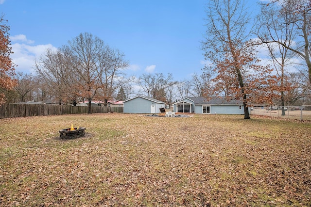 view of yard with an outdoor fire pit and a fenced backyard