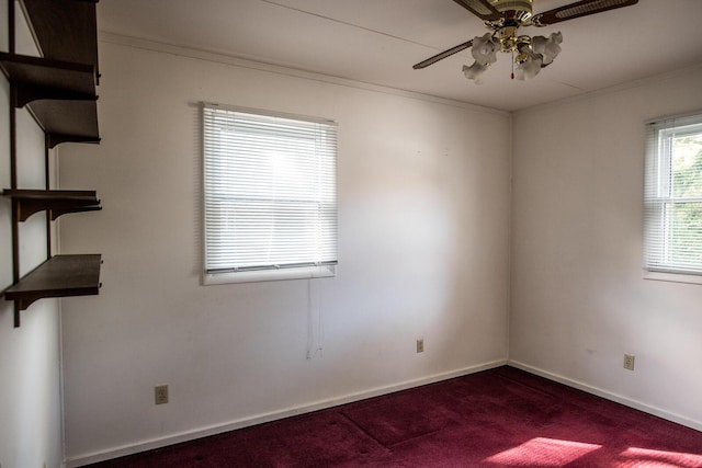 carpeted spare room with ceiling fan, ornamental molding, and baseboards