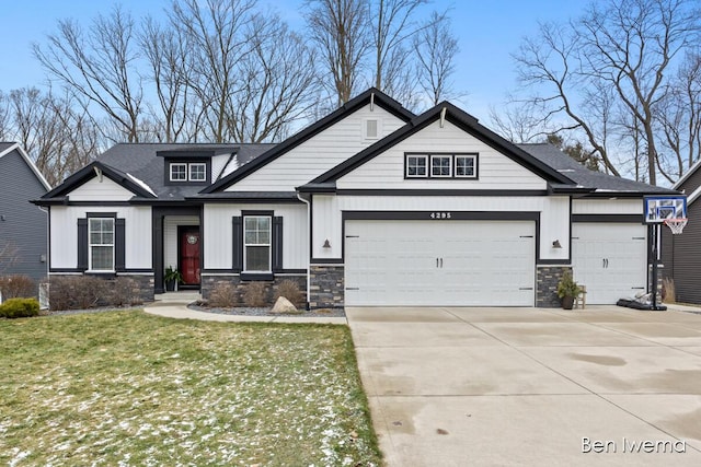 craftsman-style home featuring a garage, driveway, board and batten siding, and stone siding