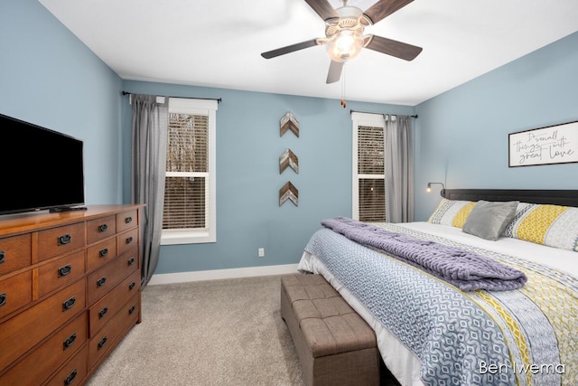 bedroom with ceiling fan, baseboards, and light colored carpet