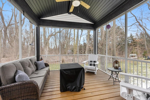 sunroom with lofted ceiling with beams and ceiling fan