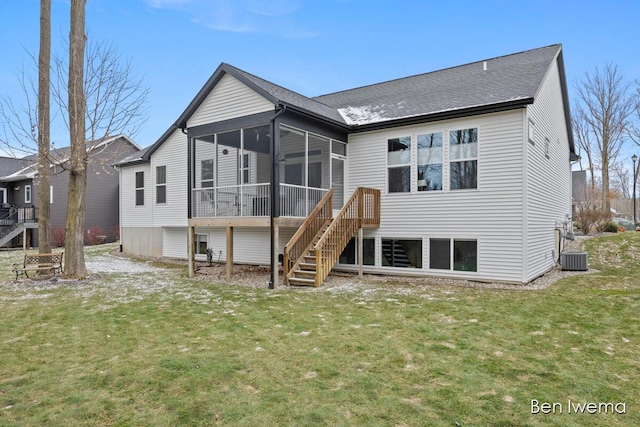 rear view of house featuring a sunroom, stairway, and a yard