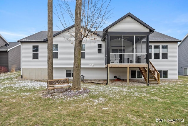 back of property with a sunroom, roof with shingles, a yard, and stairway