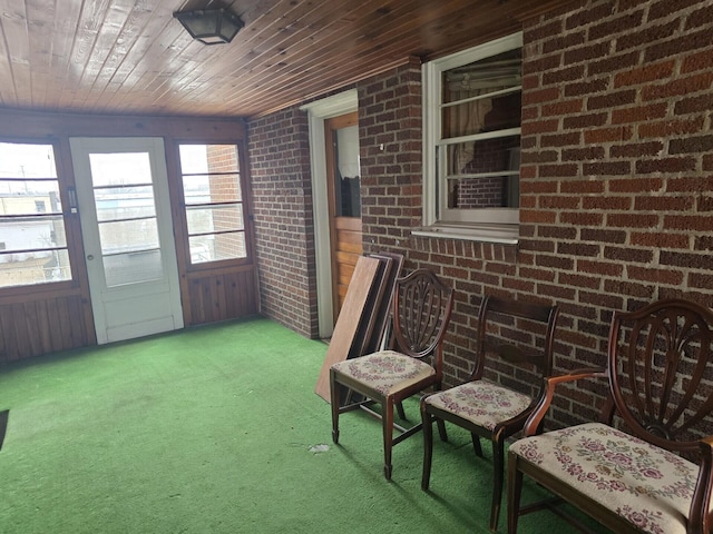 sunroom / solarium featuring wooden ceiling and a healthy amount of sunlight