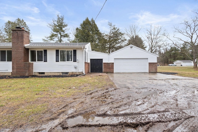 view of front of home featuring a garage, a chimney, and a front lawn