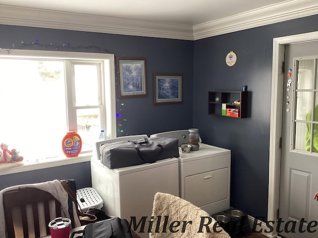 washroom with washing machine and dryer and crown molding