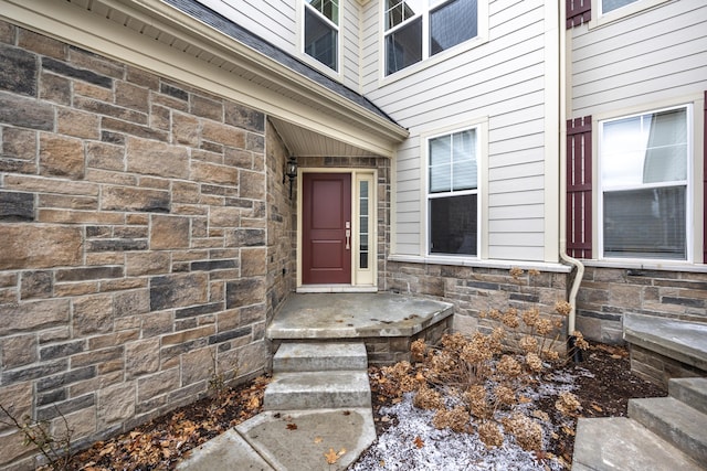 doorway to property featuring stone siding