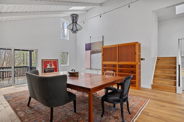 dining room featuring stairs, a wealth of natural light, and light wood-style flooring