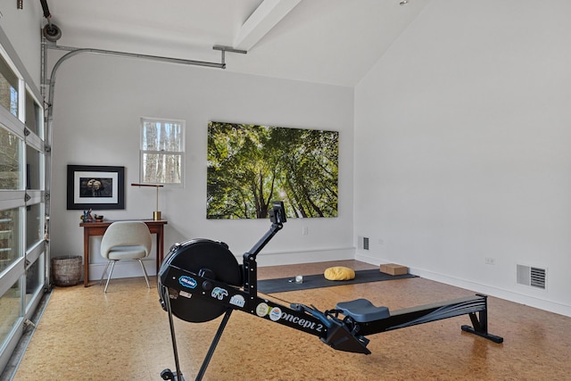 workout area with a garage, visible vents, and baseboards