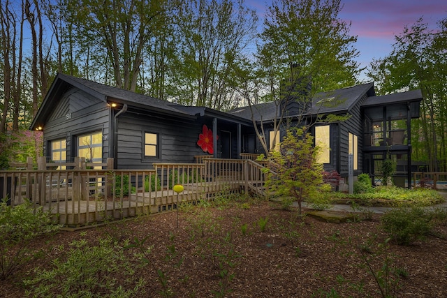 view of front facade featuring a deck and a chimney