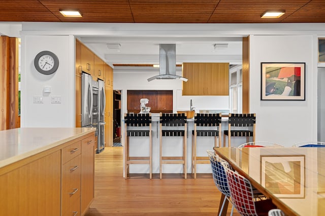 kitchen featuring a sink, light wood-style floors, smart refrigerator, modern cabinets, and island exhaust hood